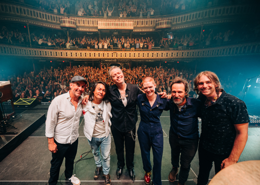 Jason Isbell and the 400 Unit on Stage with crowd behind themx